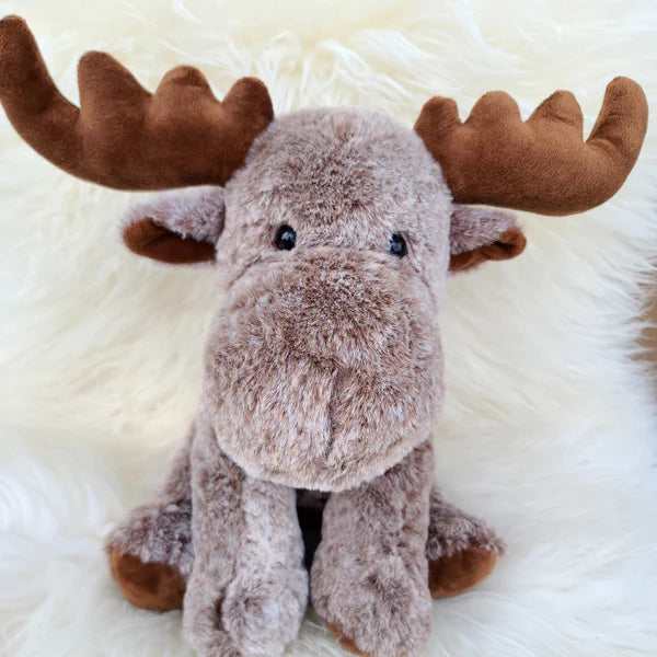 Plush moose toy on a fluffy white surface