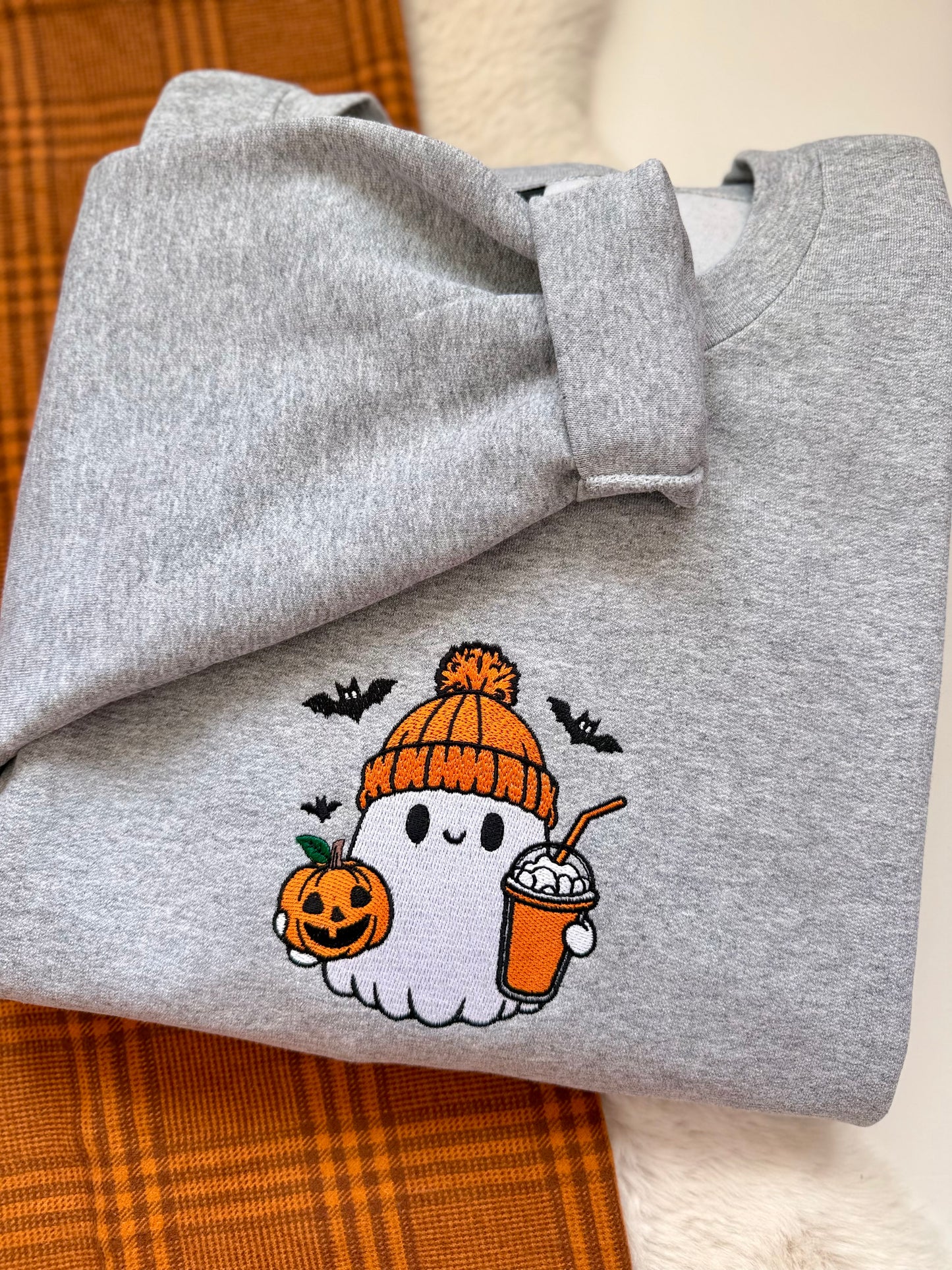Meet the ultimate autumn mood: a cute embroidered ghost rocking a cozy orange toque, clutching an iced pumpkin spice coffee and a classic jack-o'-lantern. Designed with dense, high-quality embroidery for long-lasting wear, this cozy heather grey crewneck is the perfect mix of trendy and nostalgic for everyday spooky season style.