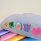 Gray knee-high sock with colorful designs on a light gray background