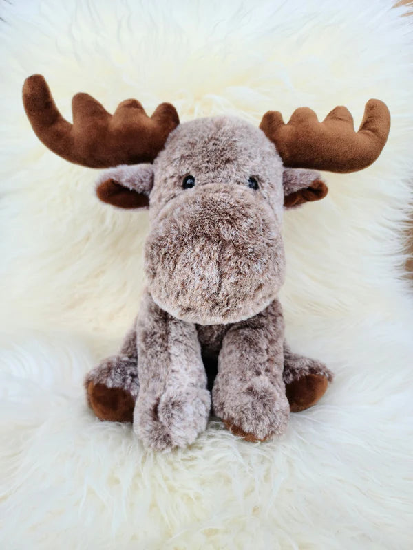 Plush moose toy on a white fluffy surface