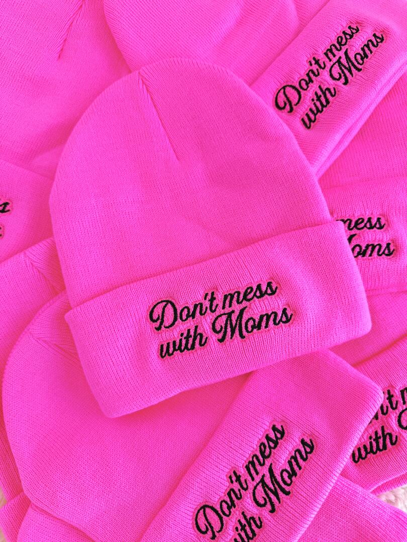 Pink beanies with 'Don't mess with Moms' text on a pink background