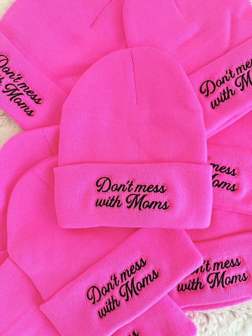 Pink beanies with 'Don't mess with Moms' text on a white background