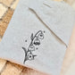 A whimsical twist on a classic botanical design, the "Ghost of the Valley" crewneck features delicate Lily of the Valley blooms transformed into subtle, charming little ghosts with embroidered sparkle accents. Minimalist, fine-line stitching gives this piece an understated cottagecore feel that works effortlessly for spooky season and beyond.

    Fine-Line Machine Embroidery: Crisp, detailed black linework designed to lay flat and hold up to daily wear.

    Subtle & Aesthetic: Perfect for those who prefer