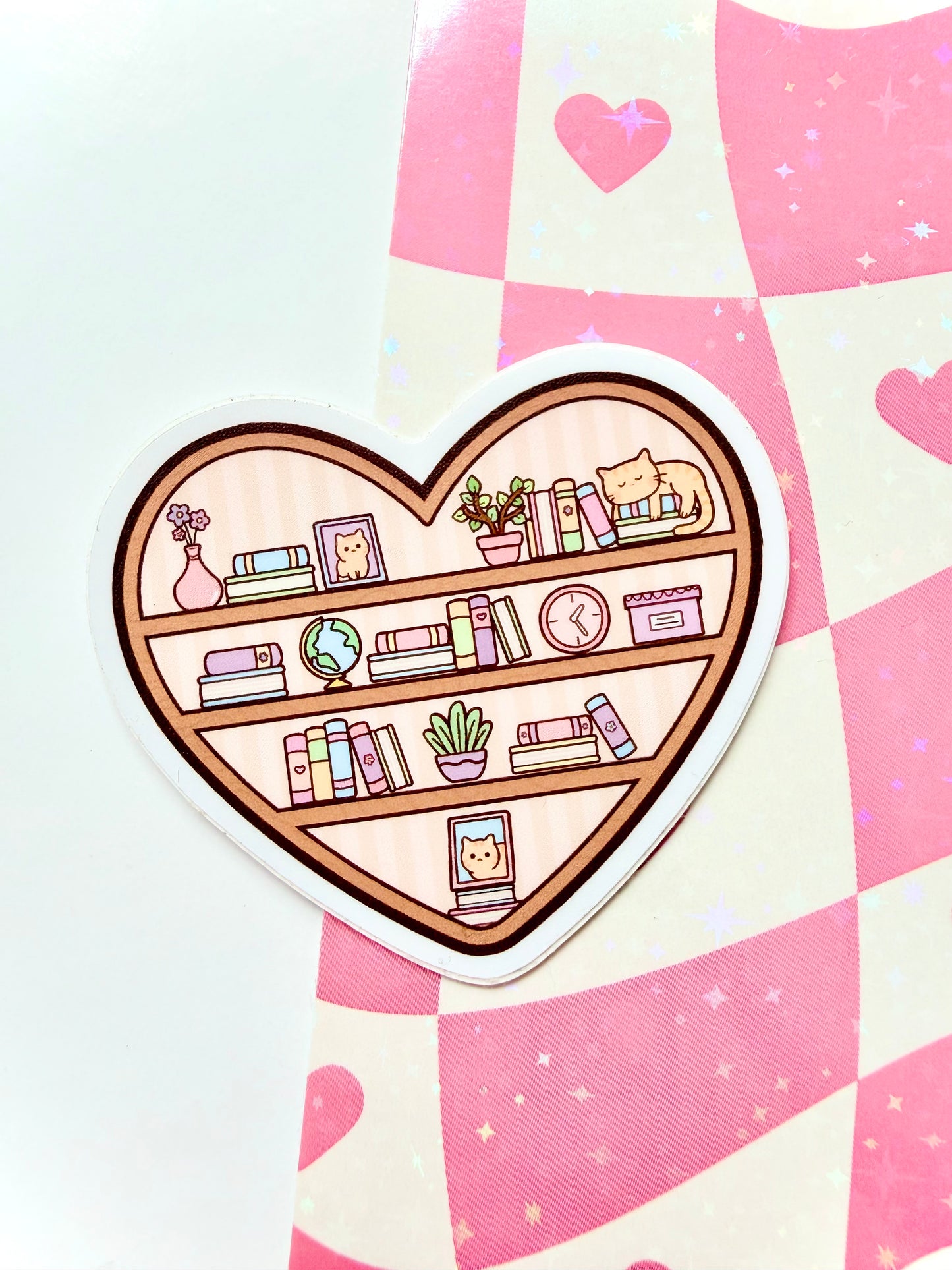 Heart-shaped bookshelf sticker on a pink and white checkered background
