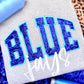 Textile with 'BLUE Jays' embroidered in blue thread on a gray fabric background.