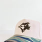 Trucker hat with floral design and wavy pattern on a white background camo