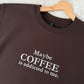 Brown sweatshirt with 'Maybe COFFEE is addicted to me.' text on a hanger against a textured white background