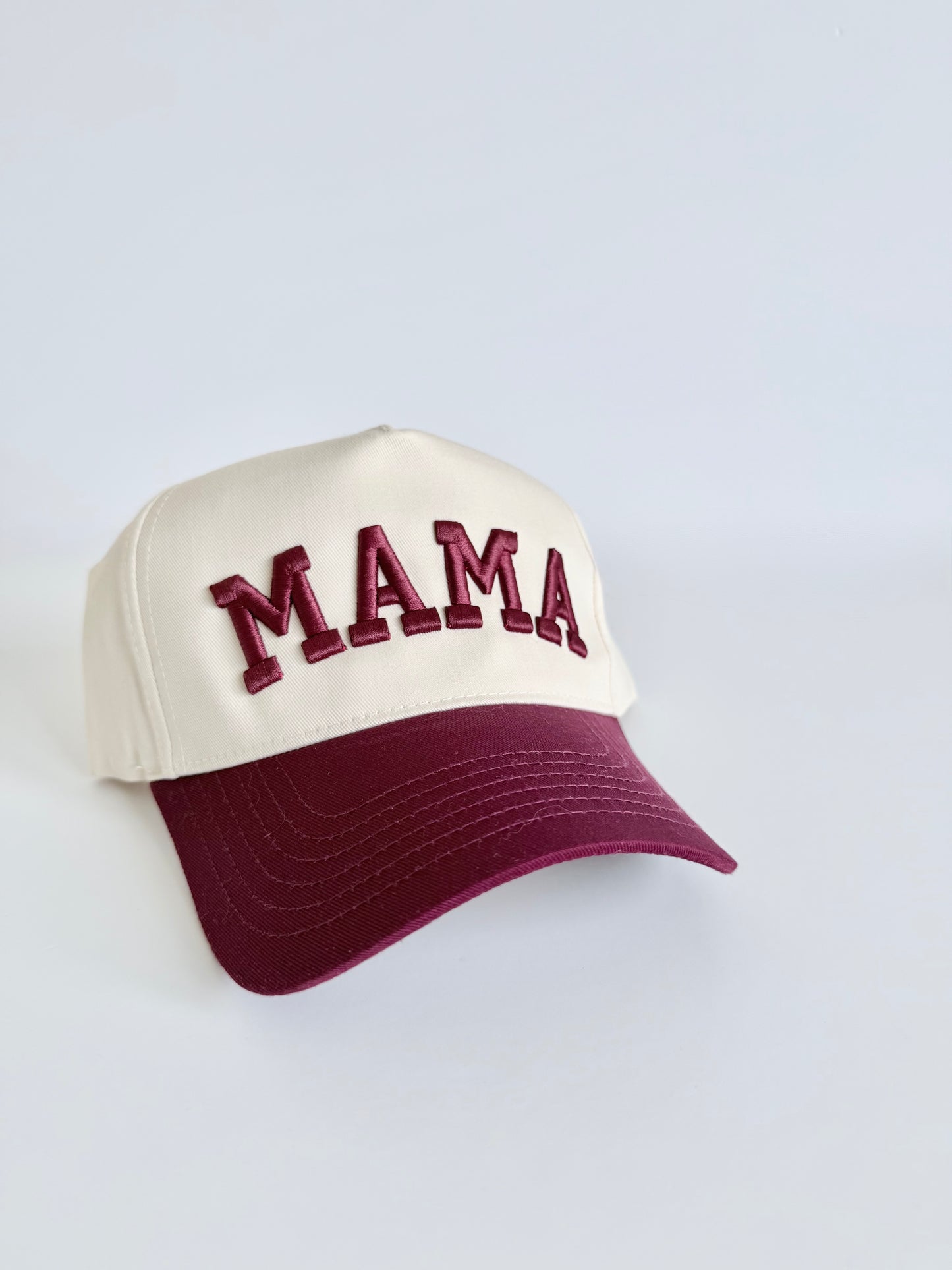 Cap with 'MAMA' text on a natural background