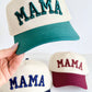 Three caps with 'MAMA' text in different colors held by a hand on a white background