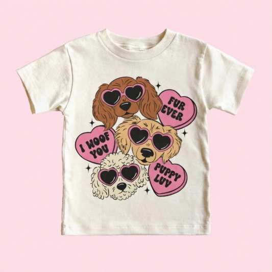 Children's t-shirt with cartoon dogs and heart-shaped text on a pink background