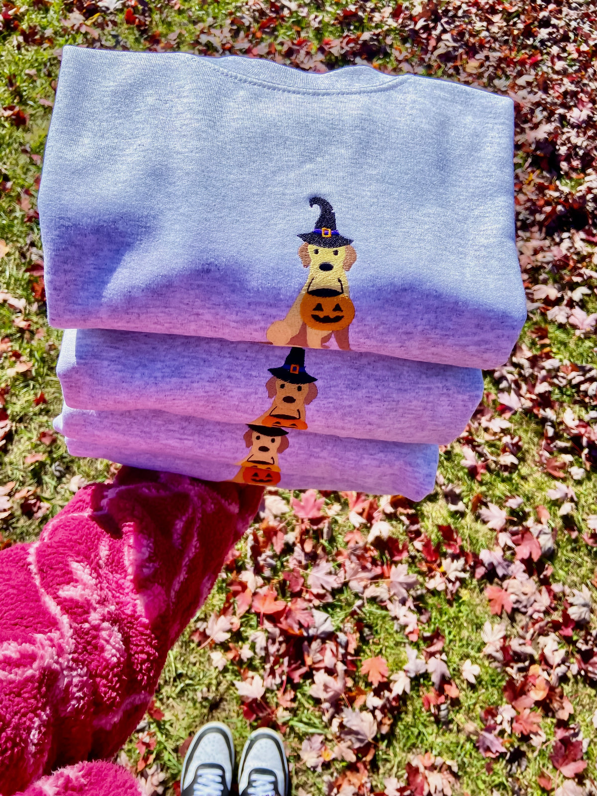 Trick or treat, but make it paw-sitively adorable!
This sweet embroidered Golden Retriever is all dressed up for Halloween in a little witch hat, complete with a pumpkin candy bucket! The perfect cozy sweater for dog lovers who love a little spooky-season cuteness.